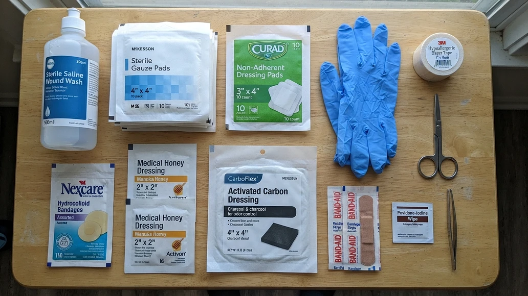 A practical home wound care kit with standard supplies and one optional charcoal dressing